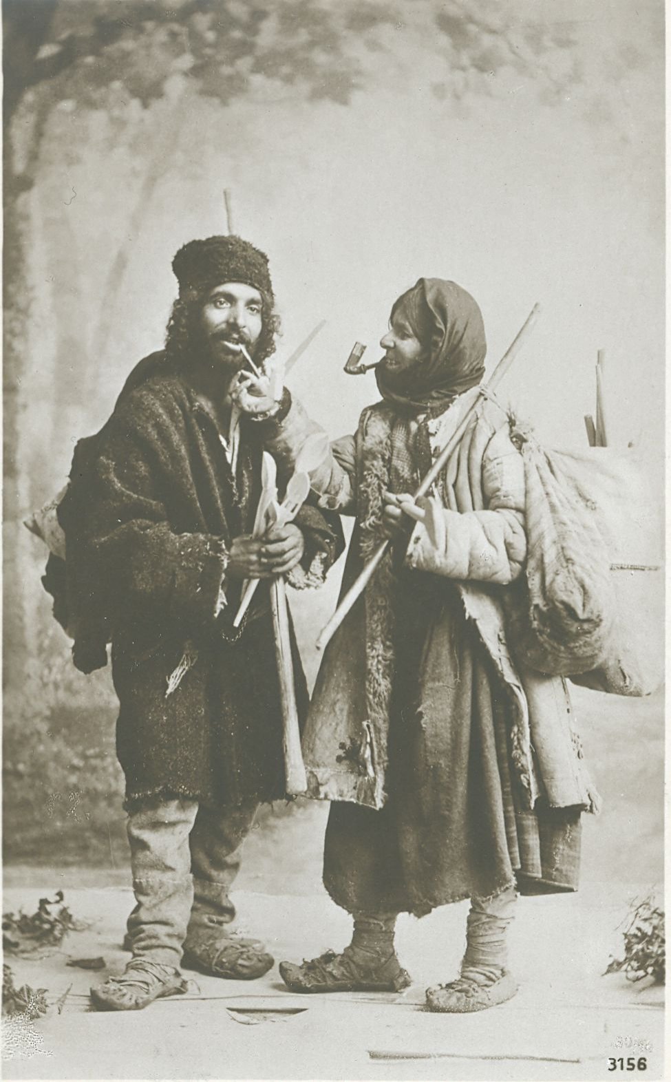 The National Archives, Romania, Roma pair (”lingurari”) sellers of their woodspoons: the woman, smoking pipe, is lighting the one of the man (end of XIXth century), ref. RO-BU-F-01073-5-642