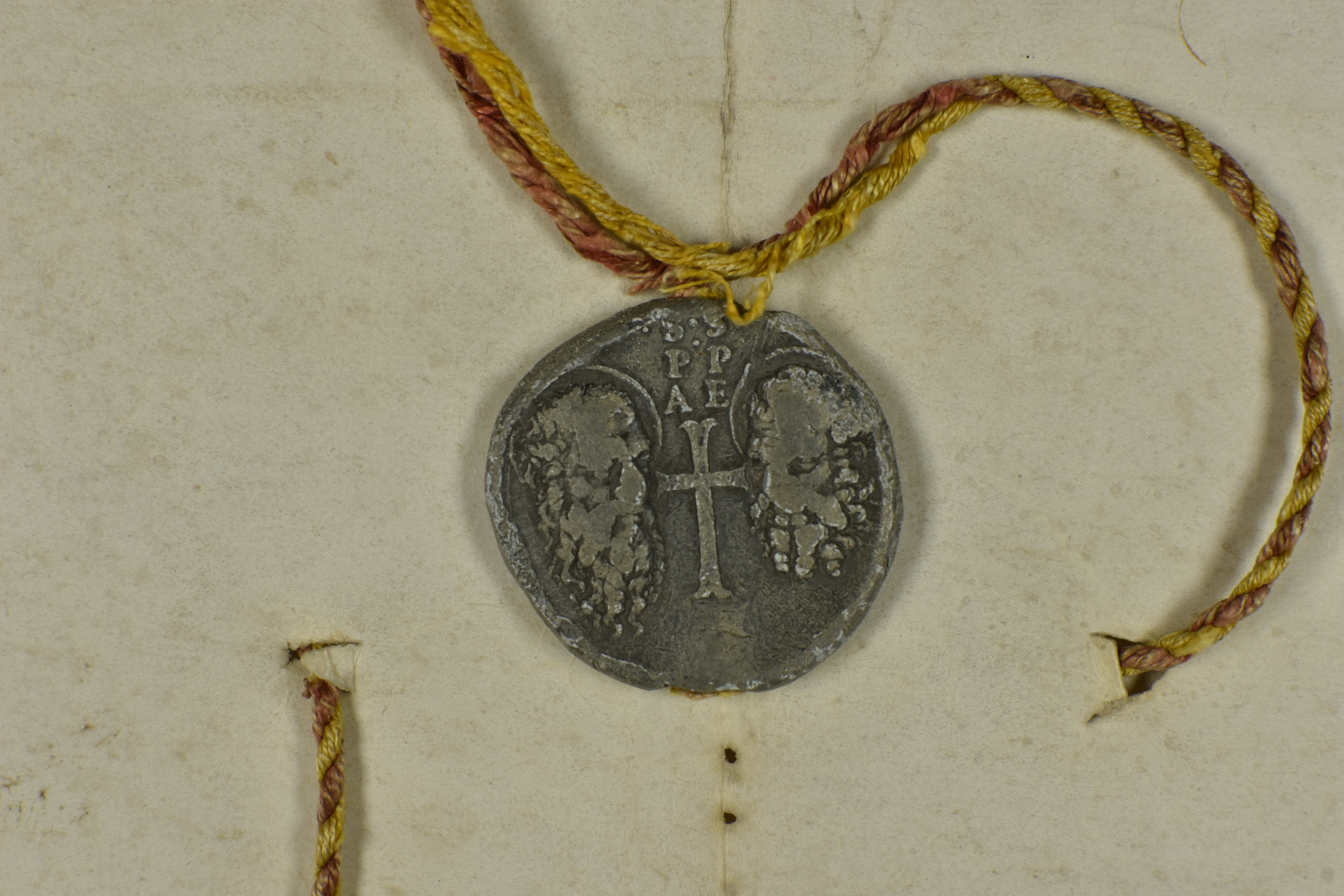 Lead seal (38 mm) is attached on a string. The obverse depicts the heads of Sts. Peter and Paul and the Cross and contains the inscription: S, P, A and S, P, E.