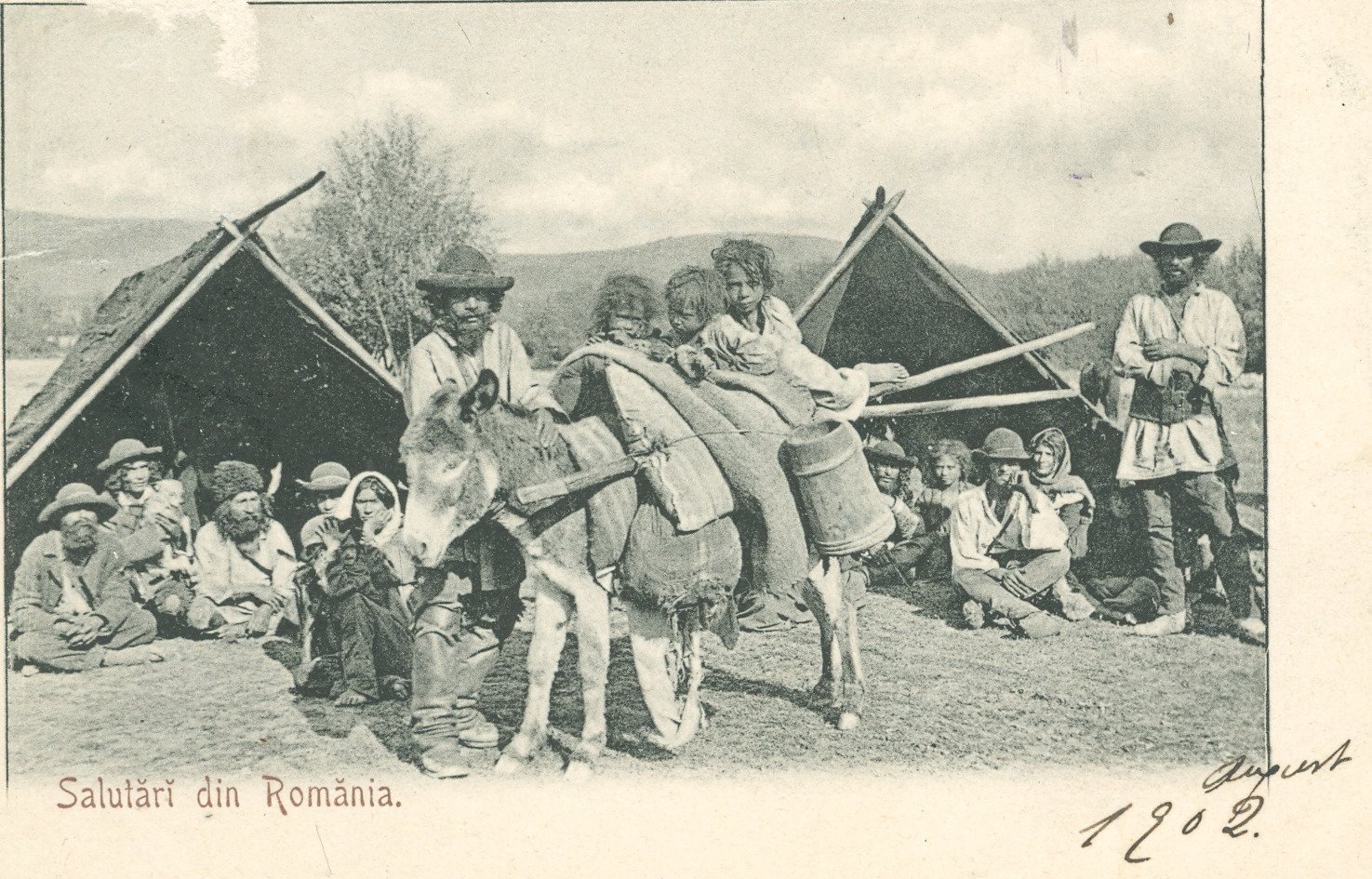 The National Archives, Romania, Postcard ”Greetings from Romania” with Nomad Roma people with tents and children ridding a donkey (1902), ref. RO-BU-F-01073-5-640-2