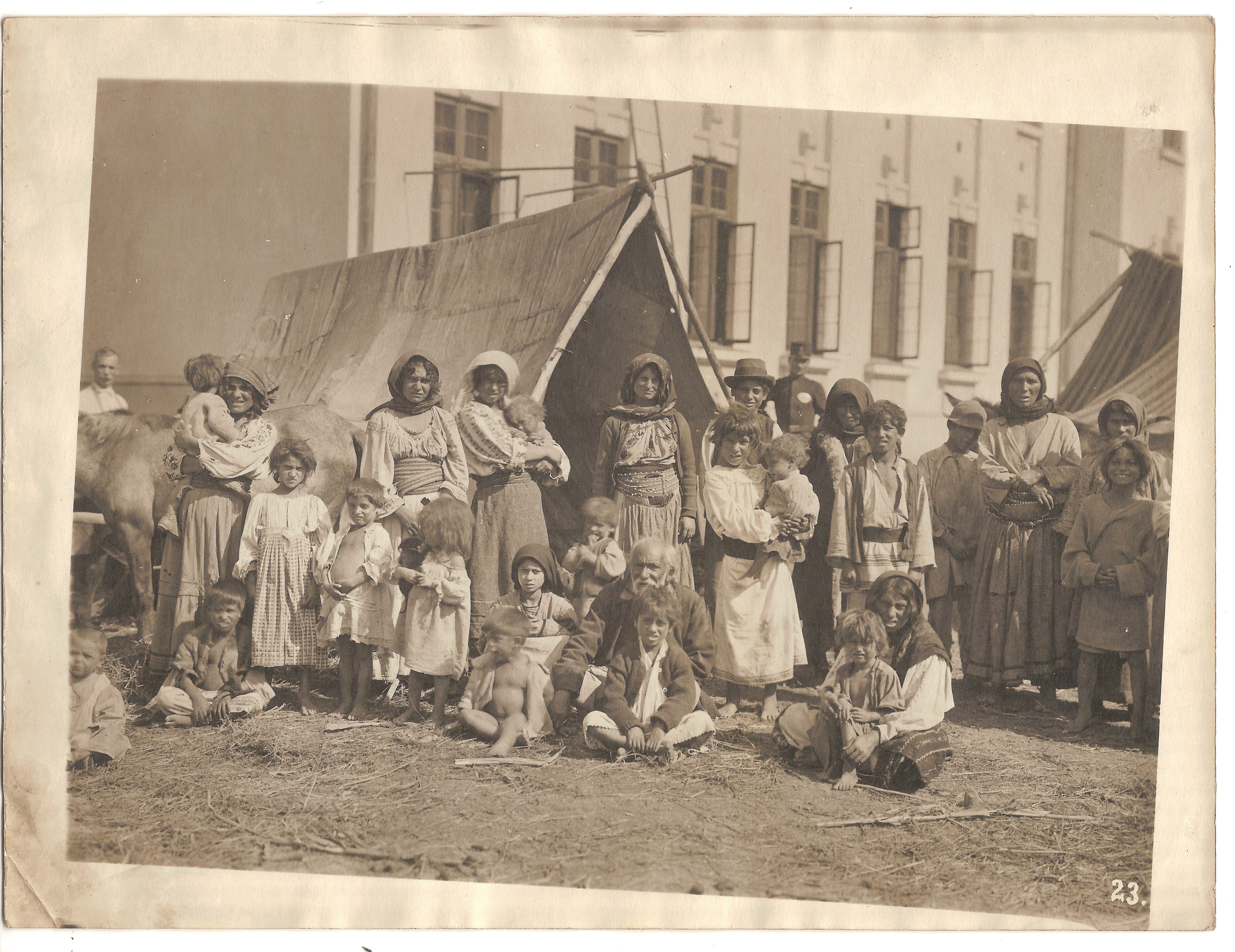 The National Archives, Romania, Large group of nomad Roma people (men, women - some wearing traditional blouse, and children) in front of a tent, ref. RO-BV-FD-00330-4-2-06 