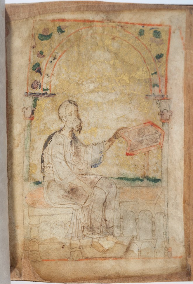 The Miniature of St. Matthew the ApostleThe miniature is preserved in the form of a loop. The draping of the clothes contours and details shown in the form of the arms indicate that the miniature was filled by highly qualified artists.  There is a scroll of writing material in the lap of the Evangelist; his left hand rests on the front of the analogion. The miniature is inserted into the dome. The background of the Evangelist, the inside part of the dome is executed in gold color.  One can see that in the past it was covered with gold leaf. The miniature is not loaded with extra details, the main emphasis directed straight at the Evangelist.